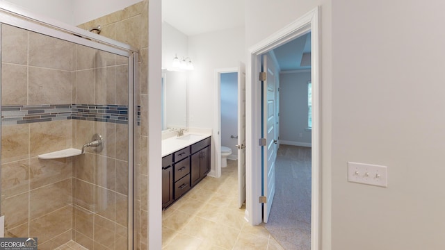 bathroom featuring vanity, toilet, and an enclosed shower