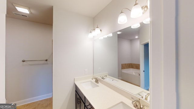 bathroom featuring vanity, tile patterned flooring, and a bathing tub