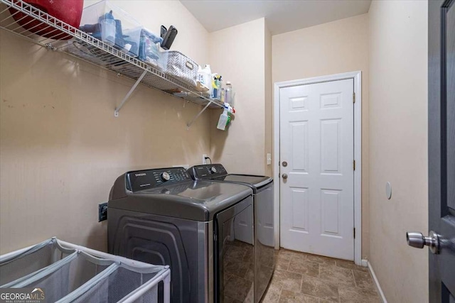 clothes washing area featuring independent washer and dryer