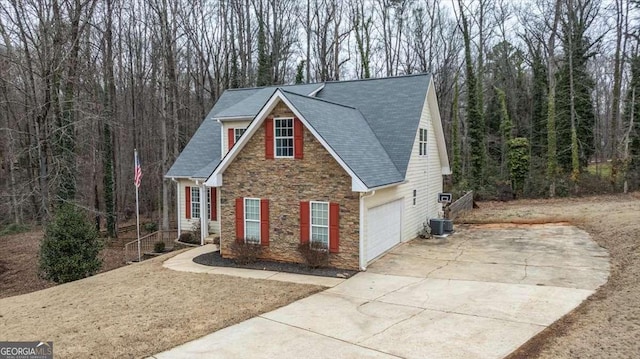 view of front of property with cooling unit and a garage