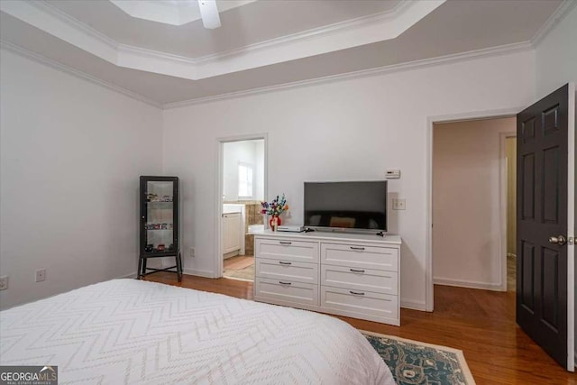 bedroom with ceiling fan, a raised ceiling, light hardwood / wood-style flooring, and crown molding