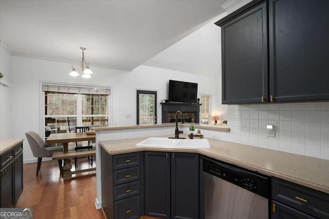 kitchen with pendant lighting, dishwasher, sink, dark hardwood / wood-style floors, and an inviting chandelier