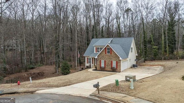 view of front of home featuring central air condition unit and a garage