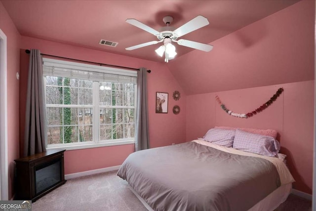 bedroom featuring lofted ceiling, light colored carpet, and ceiling fan