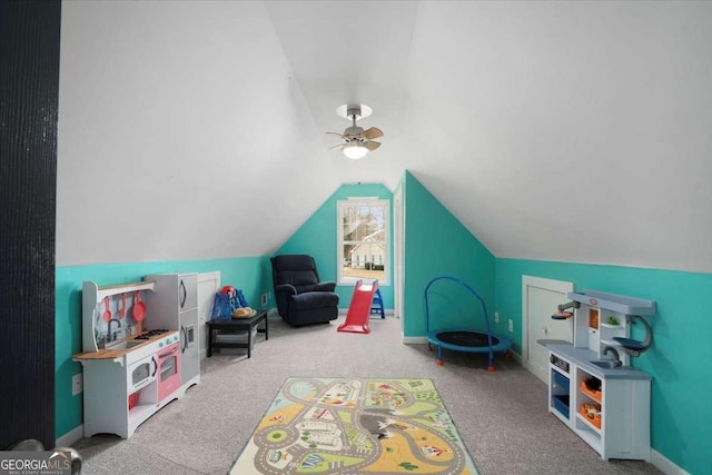 playroom featuring lofted ceiling, ceiling fan, and carpet