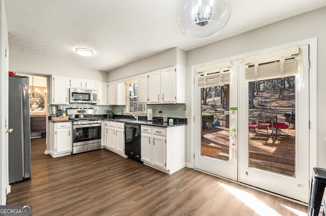 kitchen featuring backsplash, stainless steel appliances, dark hardwood / wood-style floors, and white cabinets