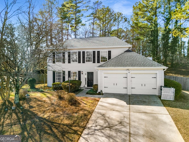 view of front of property featuring a garage and a front lawn