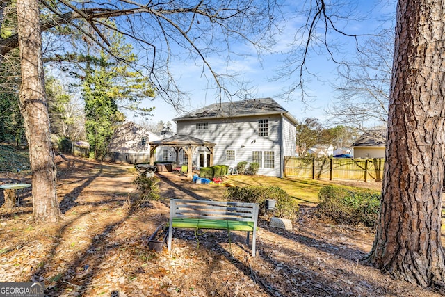 back of house featuring a gazebo