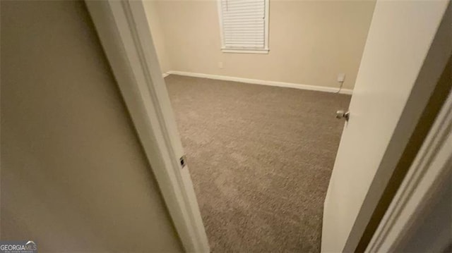 empty room with dark carpet