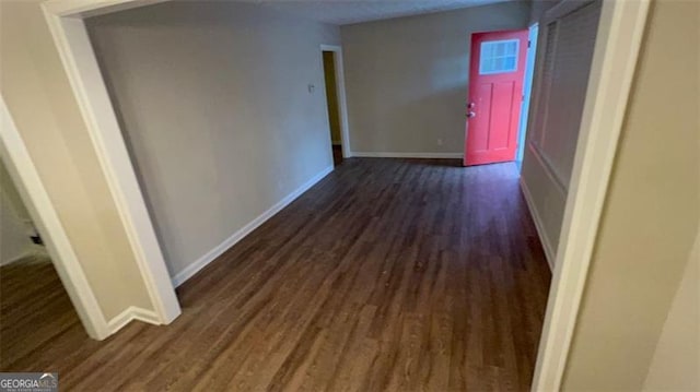 corridor featuring dark hardwood / wood-style floors