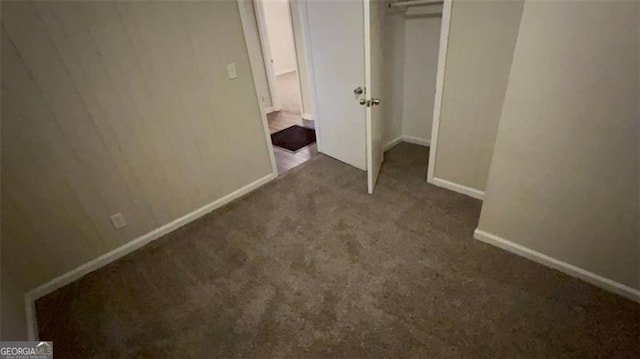 unfurnished bedroom with a closet and carpet floors