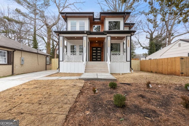 view of front of house featuring covered porch and french doors