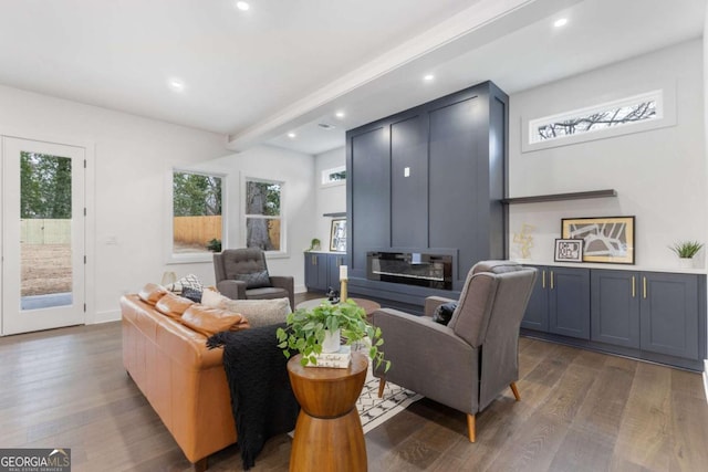 living room featuring dark hardwood / wood-style flooring and beamed ceiling