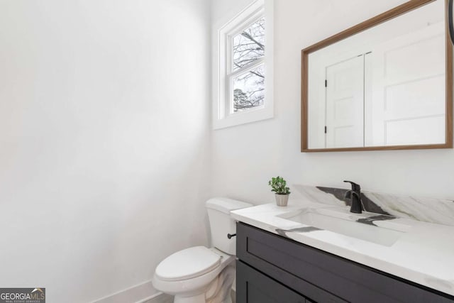 bathroom with toilet and vanity