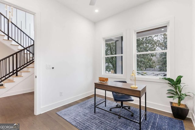 office area with ceiling fan and dark wood-type flooring