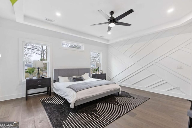 bedroom with ceiling fan and dark hardwood / wood-style flooring