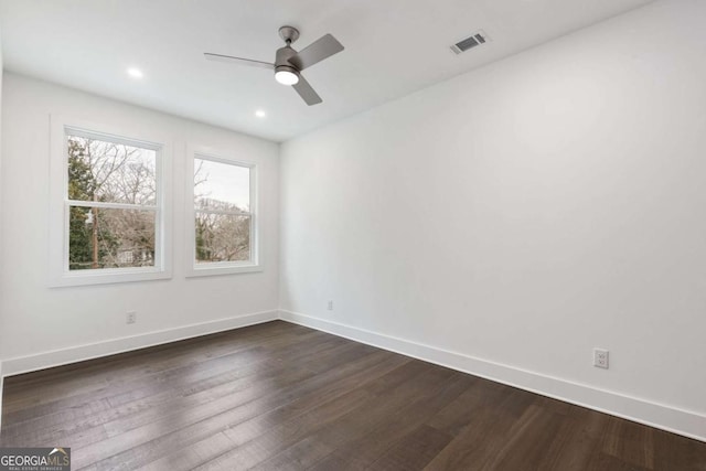 unfurnished room with ceiling fan and dark hardwood / wood-style flooring