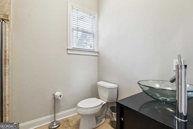 bathroom with tile patterned floors, vanity, and toilet