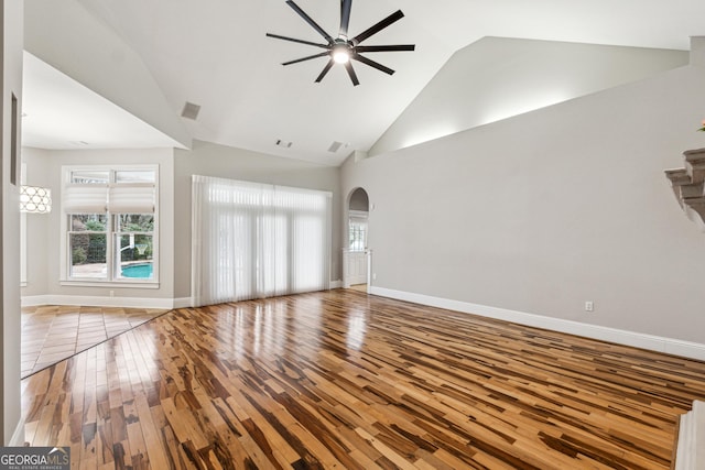 unfurnished living room featuring light hardwood / wood-style flooring, high vaulted ceiling, and ceiling fan