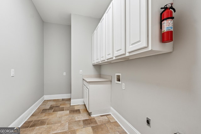 laundry room with cabinets, electric dryer hookup, and hookup for a washing machine