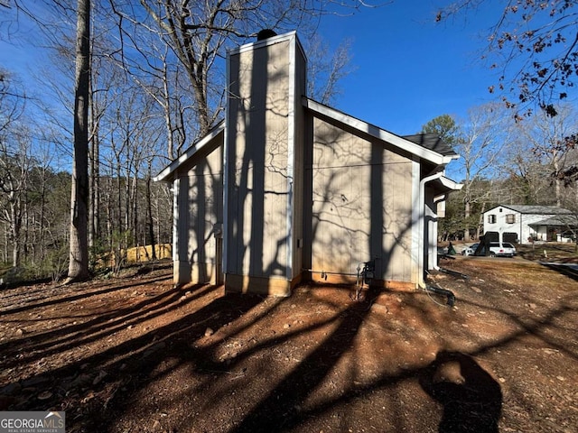 5449 Martins Crossing Rd, Stone Mountain, GA 30088 - view of side of home with a chimney