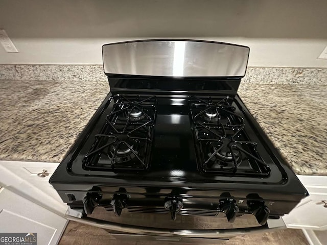 room details with range with gas cooktop and light stone countertops