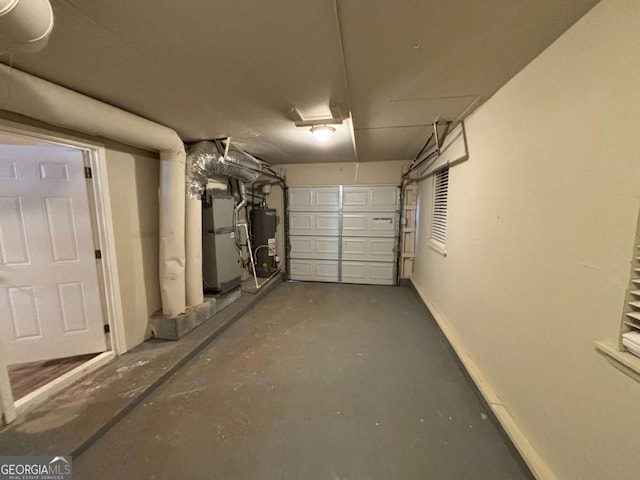 garage with water heater and heating unit