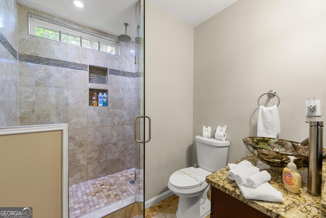 bathroom featuring sink, tile patterned floors, toilet, and walk in shower