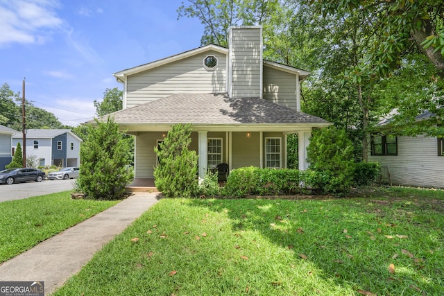 view of front of home with covered porch and a front yard