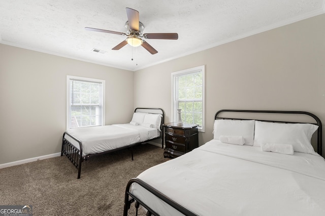 carpeted bedroom with ceiling fan, a textured ceiling, and multiple windows