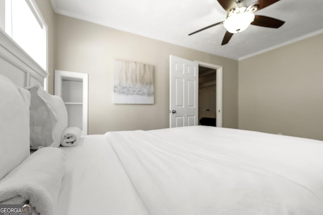 bedroom featuring ceiling fan and ornamental molding