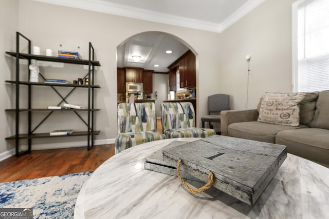 living room featuring dark wood-type flooring and ornamental molding