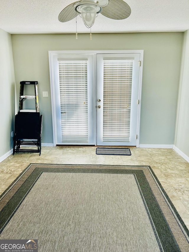 doorway featuring ceiling fan and light tile patterned flooring