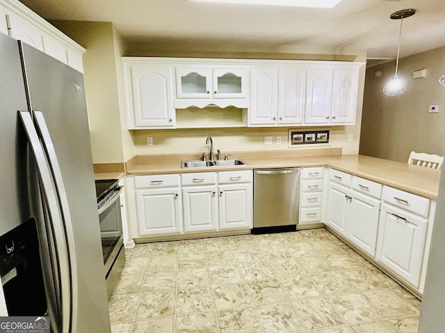 kitchen with pendant lighting, sink, white cabinetry, and stainless steel appliances