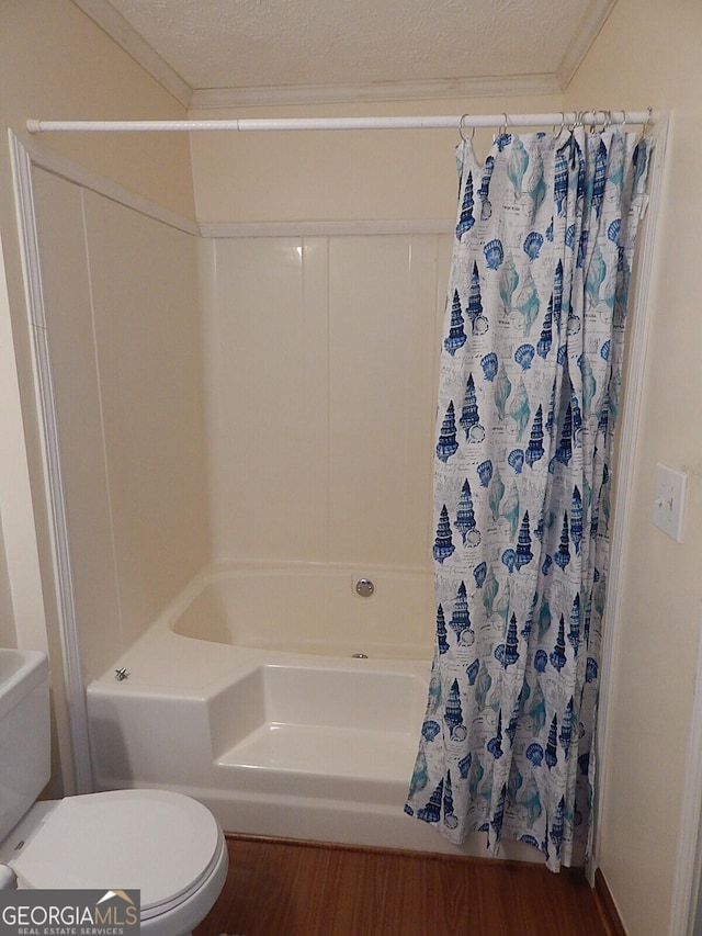 bathroom featuring crown molding, hardwood / wood-style floors, a textured ceiling, and toilet