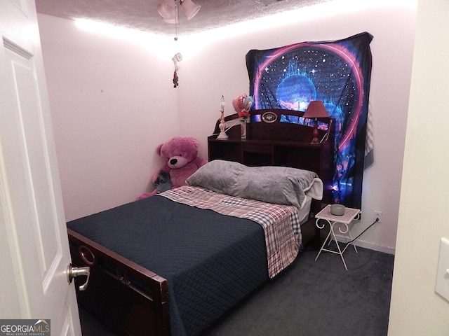 carpeted bedroom with a textured ceiling