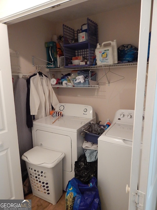 washroom featuring separate washer and dryer and wood-type flooring