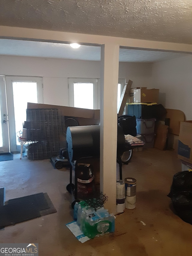 basement with plenty of natural light and a textured ceiling