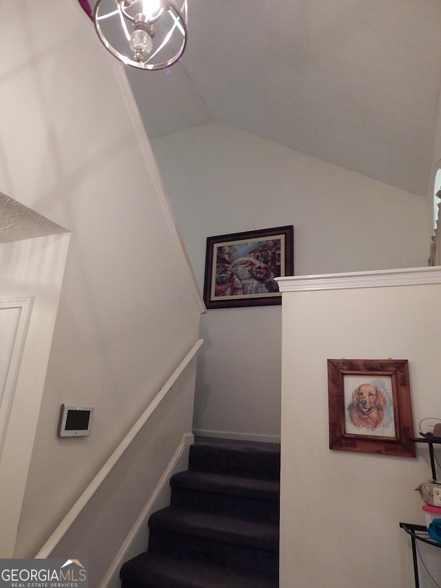 stairway with vaulted ceiling