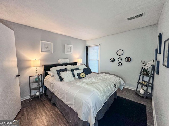 bedroom featuring dark wood-type flooring