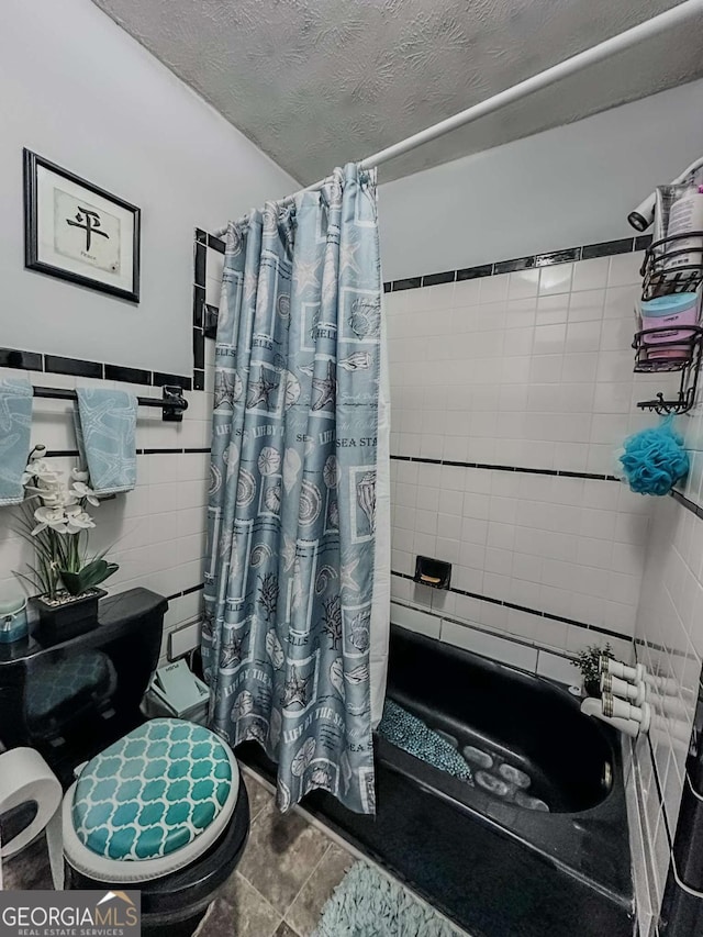 bathroom featuring tile walls, toilet, a textured ceiling, and shower / bath combo