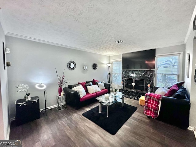 living room featuring crown molding, a textured ceiling, and dark hardwood / wood-style flooring