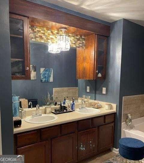 bathroom featuring a bath and vanity