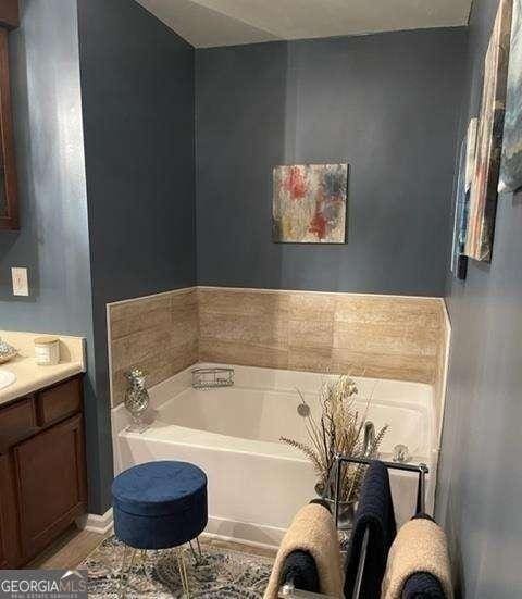 bathroom featuring a bathing tub and vanity