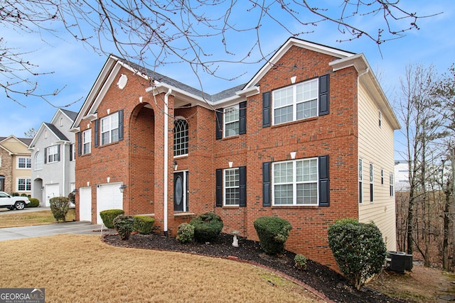 view of front of home with a garage, a front lawn, and central air condition unit