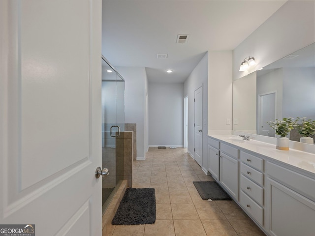 bathroom featuring tile patterned flooring, vanity, and an enclosed shower