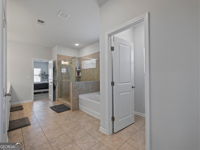 bathroom with tile patterned flooring, vanity, and plus walk in shower