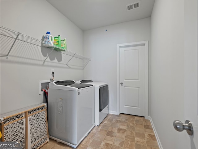 laundry room with independent washer and dryer