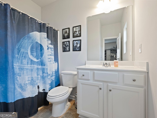 bathroom with vanity, curtained shower, and toilet