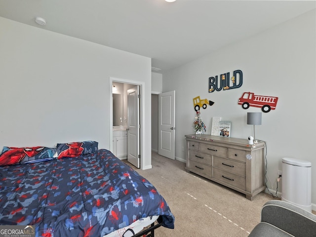 bedroom with light colored carpet and ensuite bathroom